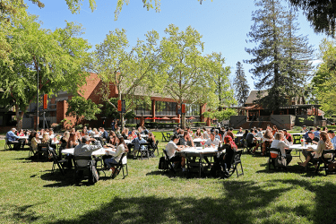 McGeorge School of Law quad. People are sitting at round tables.